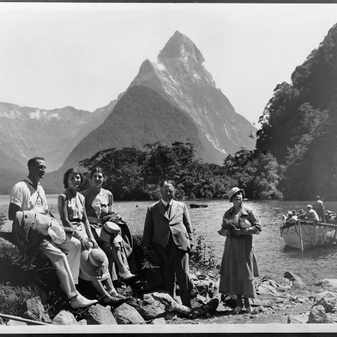 a group of people posing for a photo in front of a mountain