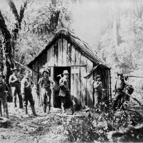 a group of people standing in front of a house
