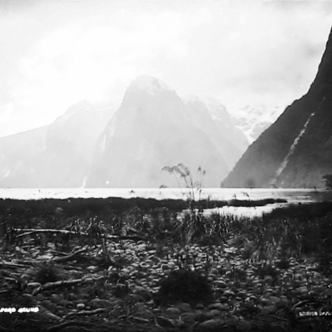 a body of water with a mountain in the background