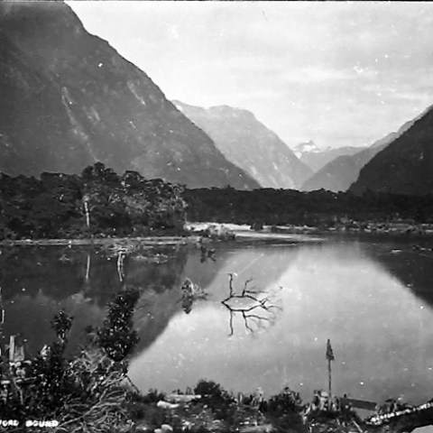 a body of water with a mountain in the background