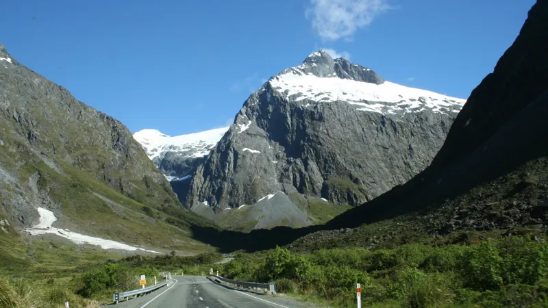 milford-Sound-By-Road a view of the side of a mountain road