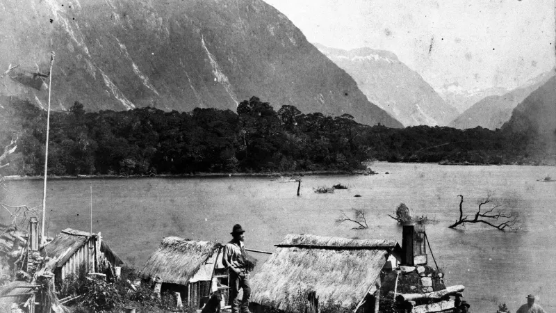 Milford Sound History tile a man riding a horse drawn carriage in front of a mountain